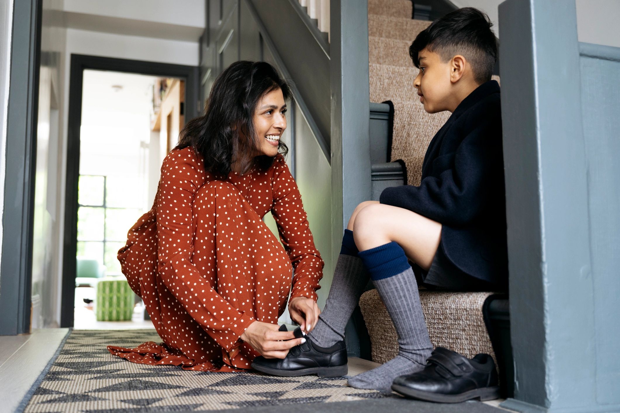 Parent helping a child get ready at home